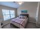 Bedroom featuring a queen-sized bed, a ceiling fan and a sunny window at 1061 Pinwheel Loop # 1061, Myrtle Beach, SC 29577