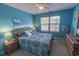 Bright bedroom with blue walls, and a queen bed with a window view at 1061 Pinwheel Loop # 1061, Myrtle Beach, SC 29577