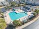 Aerial view of a community pool surrounded by lounge chairs and palm trees at 1061 Pinwheel Loop # 1061, Myrtle Beach, SC 29577