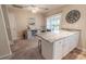 Open dining area with a large center island and modern decor leading to the patio at 1061 Pinwheel Loop # 1061, Myrtle Beach, SC 29577