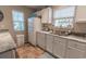 Bright kitchen featuring white cabinets, neutral countertops, and stainless steel sink under a window at 1061 Pinwheel Loop # 1061, Myrtle Beach, SC 29577