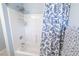 Shower over tub features a white showerhead and blue and white patterned shower curtain at 1061 Pinwheel Loop # 1061, Myrtle Beach, SC 29577