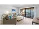 Living room featuring a sofa, coffee table and sliding door to balcony at 108 Rothbury Circle # 207, Myrtle Beach, SC 29572