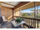 Screened balcony with table and chairs overlooking a pond at 108 Rothbury Circle # 207, Myrtle Beach, SC 29572