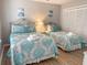 A well-lit bedroom features two beds with beautiful teal bedding and a large closet at 109 Westhill Circle # 3-C, Myrtle Beach, SC 29572