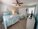 A bedroom has two beds with teal and white bedding, a ceiling fan, and a closet at 109 Westhill Circle # 3-C, Myrtle Beach, SC 29572