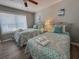 A bedroom showcases two twin beds with patterned bedding and a window at 109 Westhill Circle # 3-C, Myrtle Beach, SC 29572