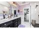 Modern bathroom with marble walls, dual vanity, walk-in closet, and a glass-enclosed shower at 116 Cypress Estates Dr., Murrells Inlet, SC 29576