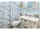 Bright bathroom with blue accents featuring a white vanity and coastal-themed decor at 116 Cypress Estates Dr., Murrells Inlet, SC 29576