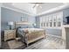 Charming bedroom with a decorative tray ceiling, wood-look floors, and bright shuttered windows at 116 Cypress Estates Dr., Murrells Inlet, SC 29576