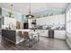 Bright kitchen with white cabinetry, stainless steel appliances, and seating at the island at 116 Cypress Estates Dr., Murrells Inlet, SC 29576