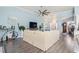 Spacious living room with hardwood floors, a ceiling fan, and large windows providing natural light at 116 Cypress Estates Dr., Murrells Inlet, SC 29576