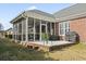 The screened-in porch with brick pavers and ceiling fan provides a perfect spot for outdoor relaxation at 116 Cypress Estates Dr., Murrells Inlet, SC 29576