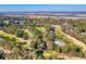 Stunning aerial view of a nearby golf course, highlighting its well-manicured greens and proximity to a serene river at 116 Great Lakes Rd., Pawleys Island, SC 29585