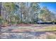 Backyard features mature trees, outdoor seating, and wooded scenery at 116 Great Lakes Rd., Pawleys Island, SC 29585