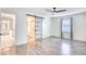 Bright bedroom with hardwood floors, ceiling fan, and an en-suite bathroom with a sliding door at 116 Great Lakes Rd., Pawleys Island, SC 29585