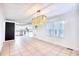 Bright dining area with a modern chandelier and a view of the kitchen with white cabinetry at 116 Great Lakes Rd., Pawleys Island, SC 29585