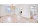 Bright dining room with tiled floors, modern chandelier, and access to the living room and hallway at 116 Great Lakes Rd., Pawleys Island, SC 29585