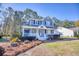 Charming two-story home featuring a lovely front porch and well-maintained landscaping at 116 Great Lakes Rd., Pawleys Island, SC 29585