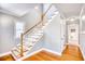 Bright foyer with hardwood floors, a staircase, and entry to the living room at 116 Great Lakes Rd., Pawleys Island, SC 29585