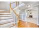 Bright foyer with hardwood floors, a staircase, and entry to the living room at 116 Great Lakes Rd., Pawleys Island, SC 29585