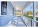 A covered side porch with a view of the front yard and beautiful surroundings at 116 Great Lakes Rd., Pawleys Island, SC 29585