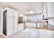 Well-lit kitchen with white cabinets, stainless steel appliances, and tiled flooring at 116 Great Lakes Rd., Pawleys Island, SC 29585