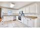 Clean kitchen featuring white cabinetry, stainless steel appliances, and tiled floors at 116 Great Lakes Rd., Pawleys Island, SC 29585