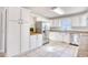 Bright and airy kitchen features white cabinets, stainless steel appliances, and tiled flooring at 116 Great Lakes Rd., Pawleys Island, SC 29585