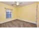 Bright bedroom with neutral carpet, a ceiling fan and a large window at 118 Birch N Coppice Dr. # 3, Surfside Beach, SC 29575