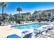 Community pool with lounge chairs and tropical landscaping around condo complex at 118 Birch N Coppice Dr. # 3, Surfside Beach, SC 29575