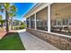 Screened-in pool house with tables, chairs, and ceiling fans for comfortable outdoor gatherings at 118 Birch N Coppice Dr. # 3, Surfside Beach, SC 29575