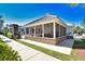 Exterior view of screened in pool house with tables and chairs for outdoor relaxation and socializing at 118 Birch N Coppice Dr. # 3, Surfside Beach, SC 29575