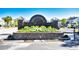 Stone community entrance sign adorned with flowers and lush landscaping at 118 Birch N Coppice Dr. # 3, Surfside Beach, SC 29575