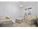 Inviting sitting room boasts natural light, stylish furniture, and a modern geometric chandelier at 1196 Fiddlehead Way, Myrtle Beach, SC 29579