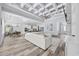 Bright open-concept living room with coffered ceilings, wood floors, and views of the kitchen and dining area at 1196 Fiddlehead Way, Myrtle Beach, SC 29579