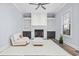 Bright living room featuring a white brick fireplace with built-in bookshelves and a comfortable armchair at 1196 Fiddlehead Way, Myrtle Beach, SC 29579