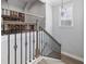 Elegant staircase with wrought iron railing and wooden banister leading to the upper level at 1196 Fiddlehead Way, Myrtle Beach, SC 29579