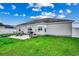 Backyard view featuring a concrete patio, outdoor seating, a grill, and a well-maintained lawn at 124 Blue Jacket Dr., Galivants Ferry, SC 29544