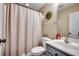 Well-lit bathroom with a shower and tub combination, a gray vanity, and decorative accents at 124 Blue Jacket Dr., Galivants Ferry, SC 29544