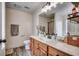 Bathroom features a modern vanity with wood cabinets, a white countertop, sleek fixtures, and a decorative mirror at 124 Blue Jacket Dr., Galivants Ferry, SC 29544