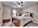 Cozy bedroom featuring a dark wood bed frame, neutral walls, a ceiling fan, and soft, neutral-colored bedding at 124 Blue Jacket Dr., Galivants Ferry, SC 29544