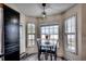 Bright breakfast nook with a round table set next to large windows offering ample natural light and charming views at 124 Blue Jacket Dr., Galivants Ferry, SC 29544