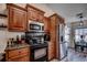 This kitchen features stainless steel appliances, wood cabinets, granite countertops, and seamlessly connects to the dining area at 124 Blue Jacket Dr., Galivants Ferry, SC 29544