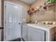 Functional laundry area with white washer and dryer, shelving, and a door for easy access at 124 Blue Jacket Dr., Galivants Ferry, SC 29544