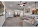 Inviting living room with cozy sectional sofa, ceiling fan, and view to dining at 124 Blue Jacket Dr., Galivants Ferry, SC 29544