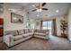 Inviting living room with cozy sectional sofa, ceiling fan, and view to back at 124 Blue Jacket Dr., Galivants Ferry, SC 29544