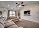 Bright living room with cozy sectional, ceiling fan, and view to back at 124 Blue Jacket Dr., Galivants Ferry, SC 29544