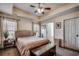 Spacious bedroom with a tray ceiling, ceiling fan, and neutral color scheme, offering comfort and elegance at 124 Blue Jacket Dr., Galivants Ferry, SC 29544