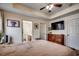 Inviting bedroom featuring a tray ceiling, wood dresser, ensuite bathroom, and television for ultimate relaxation at 124 Blue Jacket Dr., Galivants Ferry, SC 29544